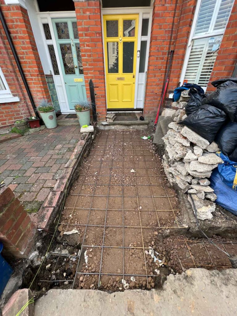 The process of laying a victorian path showing the site before