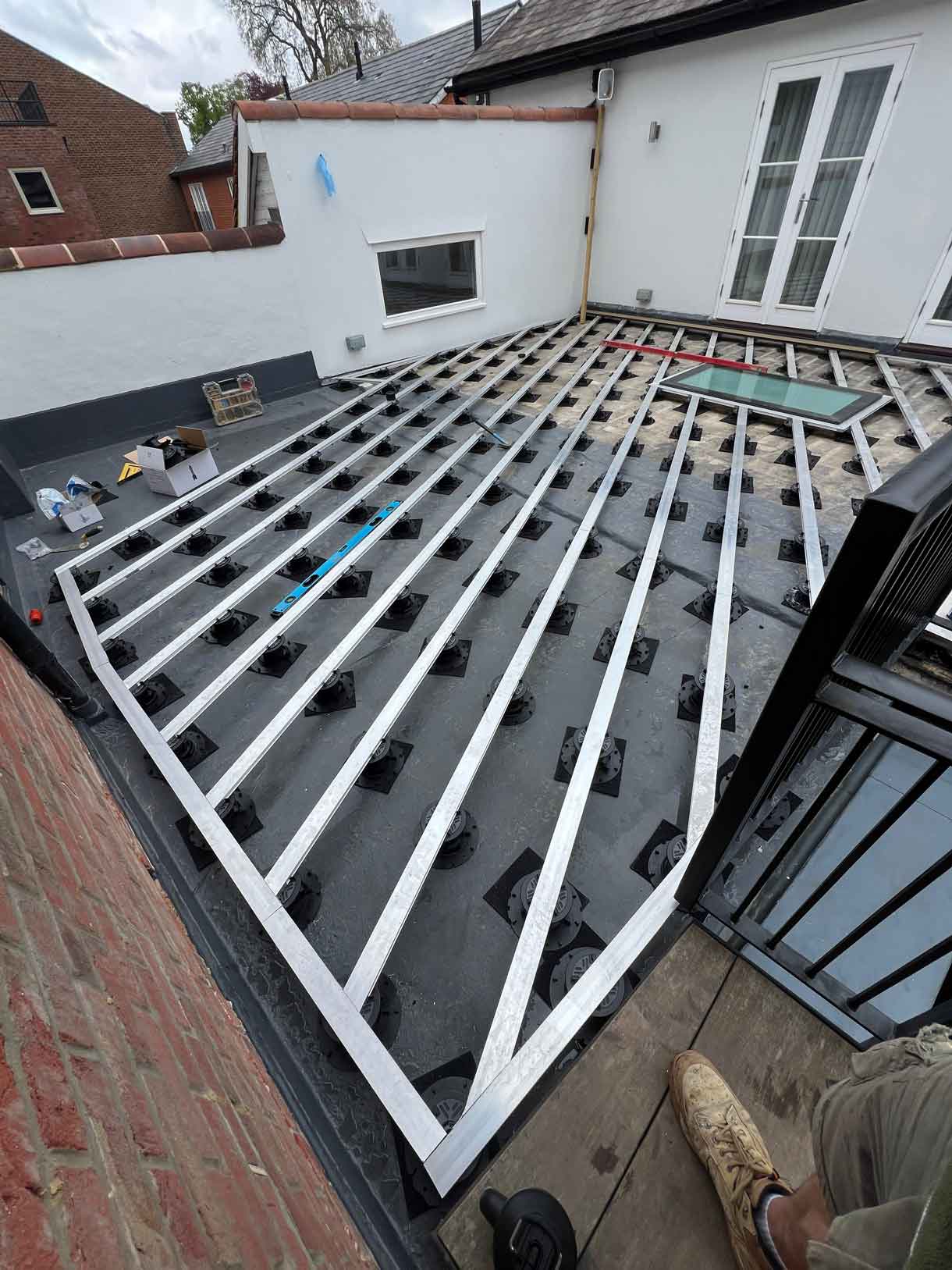 Close-up of decking pedestal system under construction.
