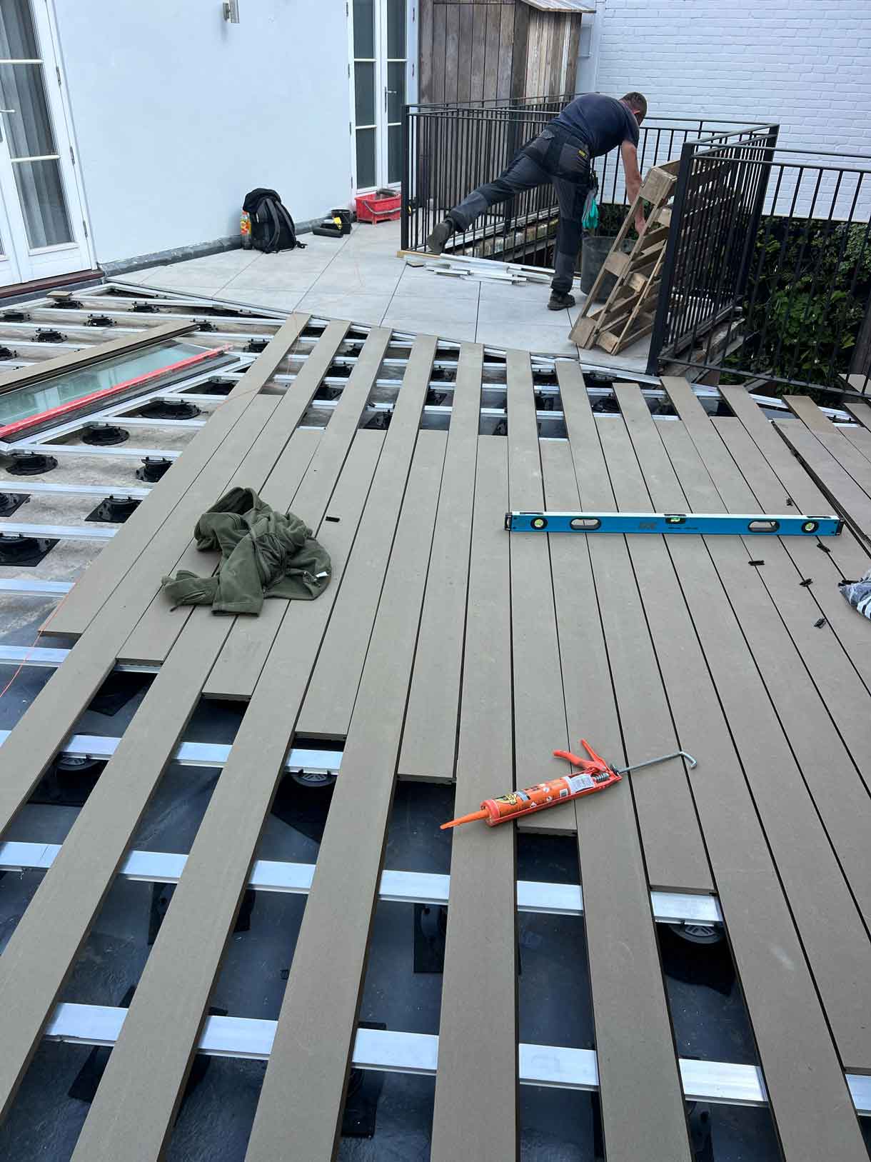 View of roof terrace with large planters and seating area.