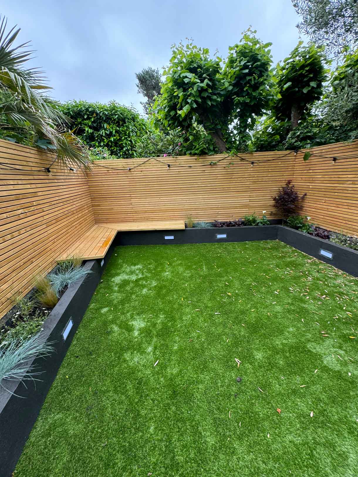 Roof terrace mid-construction with old decking removed and skylight visible.