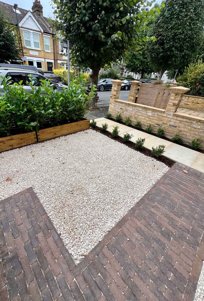 Flowering border with lush planting along a slatted timber fence.