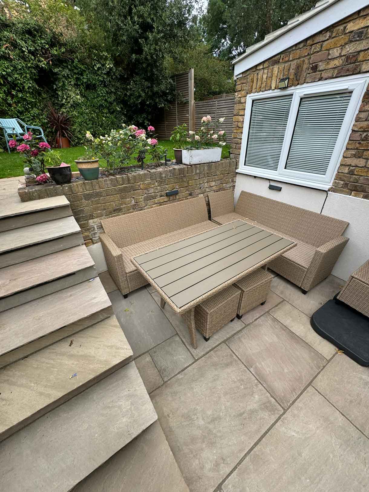 Rear garden viewed from above, showing steps, paving and raised beds.